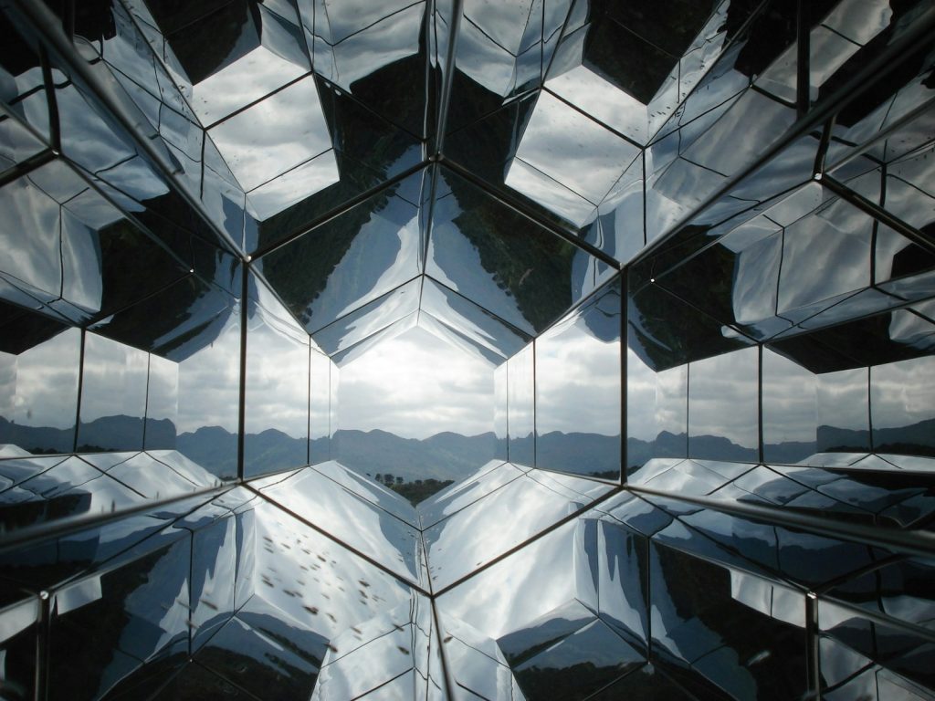 the reflection of the sky in the glass of a building