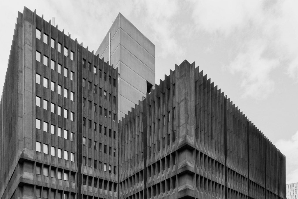 Brutalist concrete buildings against a cloudy sky