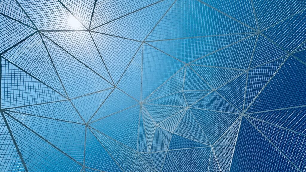 Abstract geometric structures against a blue sky.